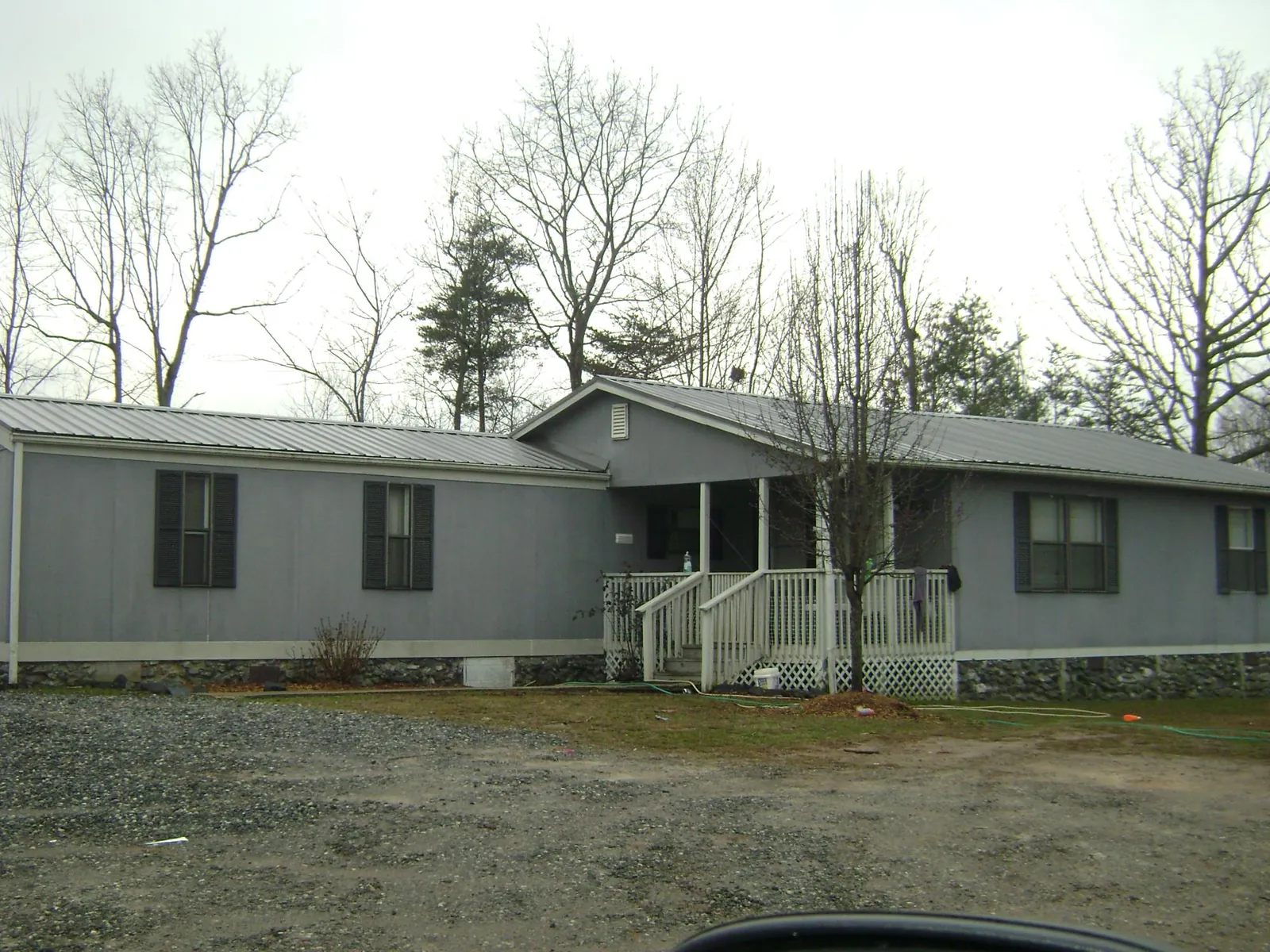 Metal roof over a manufactured home with a covered front porch in Clemons