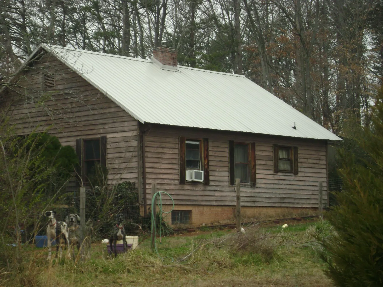 White metal roof on an old wood sided farmhouse, from a Metal Roof Installation job in Clemons